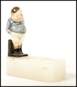 A Royal Doulton figurine pipe holder having a figu