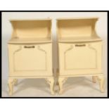 A pair of 20th century shabby chic French Louis 16th revival bedside cabinet raised on sabre style