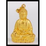 A Chinese 24ct gold pendant in the form of a Buddha, a highly detailed figurine sitting in the lotus