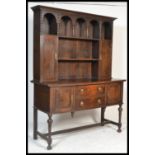 A large  1920's Jacobean revival oak Welsh dresser base raised on turned and block legs with