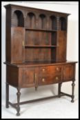 A large  1920's Jacobean revival oak Welsh dresser base raised on turned and block legs with