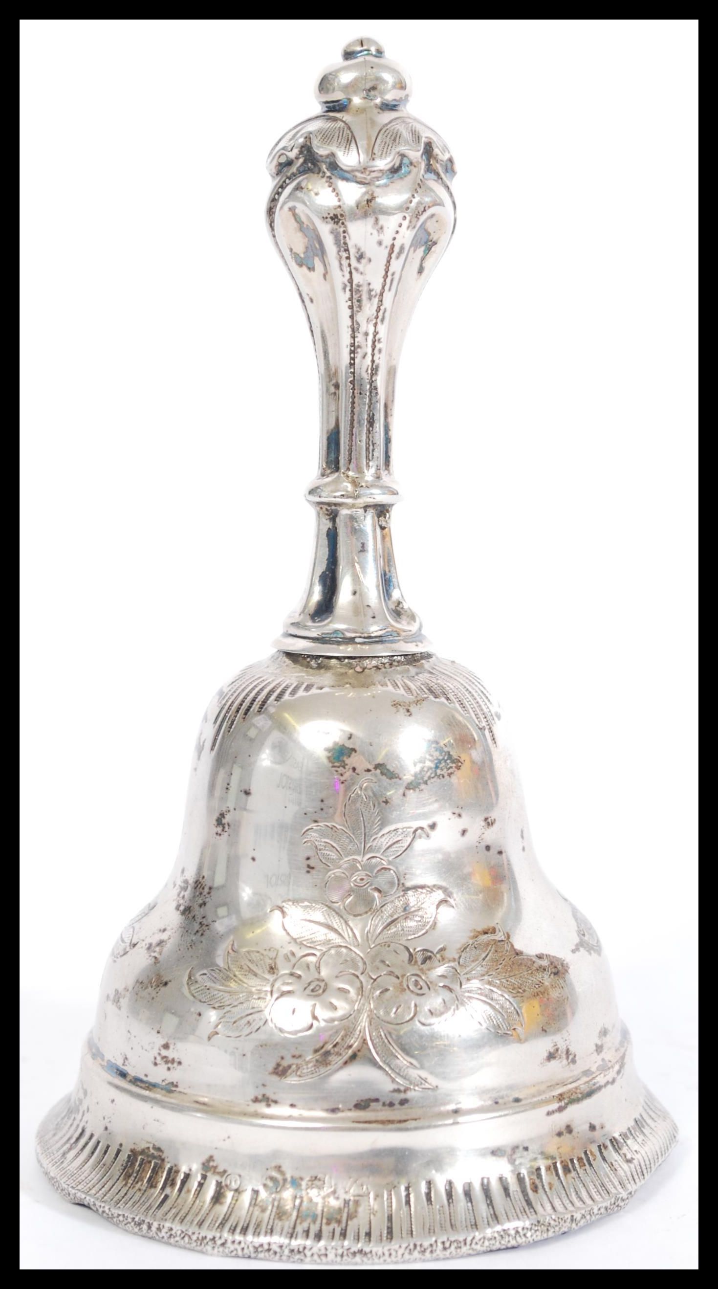 A silver bell having a bronze clanger, being engraved with floral detailing and decorative - Image 2 of 4