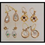 A group of 9ct gold earrings to include square white stone ring drops, green and white stone