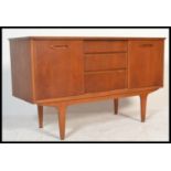 A retro 1970's small proportion teak sideboard raised on tapered legs with sliding door cupboards