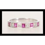 A stamped 18ct white gold ring channel set with square rubies and diamonds. Weight 2.6g. Size L.