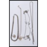 A selection of silver necklaces to include a heart pendant necklace having pierced decoration, a