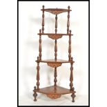 A 19th century Victorian mahogany and marquetry inlaid whatnot etagere having turned column supports