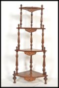 A 19th century Victorian mahogany and marquetry inlaid whatnot etagere having turned column supports
