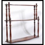 A 19th Century Victorian mahogany set of graduating wall shelves of waterfall shape with turned