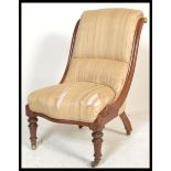 A Victorian mahogany 19th century nursing chair being raised on ring turned legs with castors,
