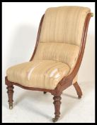 A Victorian mahogany 19th century nursing chair being raised on ring turned legs with castors,