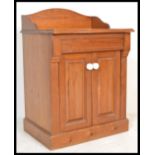 A Victorian pine washstand - hall cabinet. The cabinet of pedestal form with gallery top over