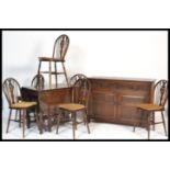 A Jaycee / Old Charm dining room suite comprising a set of 6 wheelback dining chairs, a drop leaf