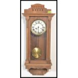 An early 20th Century Edwardian Vienna style oak cased wall clock, silvered dial, Roman numeral