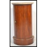 An early 20th Century Edwardian mahogany circular marble topped wash stand pedestal cupboard, the