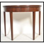 A 19th Century Georgian mahogany line inlay demi lune fold over tea / cards games table raised on