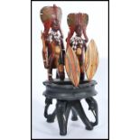 A vintage early 20th century African ebony ashtray raised on a carved elephant base with African