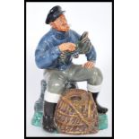 A Royal Doulton ceramic figurine entitled The Lobster Man HN2317 modelled on a naturalistic base