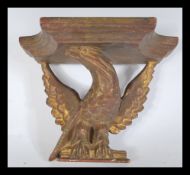A 19th Century giltwood ormolu wall bracket in the form of an eagle on perch.