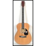 A vintage Martin Smith acoustic six string guitar model W100NPK. The shaped hollow body having an