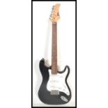 A vintage Power Play Stratocaster style electric six string guitar having a black body with white