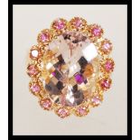 A hallmarked 9ct gold ladies dress ring set with a large Medina Morganite with a halo of Pink