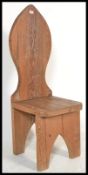 A 20th Century oak chair having a tall arched back with bracketed supports. Measures 122cm high x