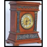 An early 20th Century mantel clock made by British United Clock co. having a gilt face with embossed