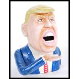 A novelty Donald Trump vintage style cast iron mon