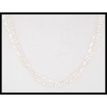 A double row freshwater pearl necklace having a silver clasp. Measures 52cm long.