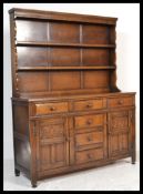 A 20th century Jacobean revival oak dresser in the manner of Jaycee / Old Charm. Plate rack to the