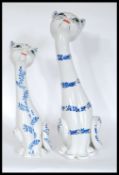 A graduating pair of retro  20th Century Italian tall long necked ceramic cats decorated in the