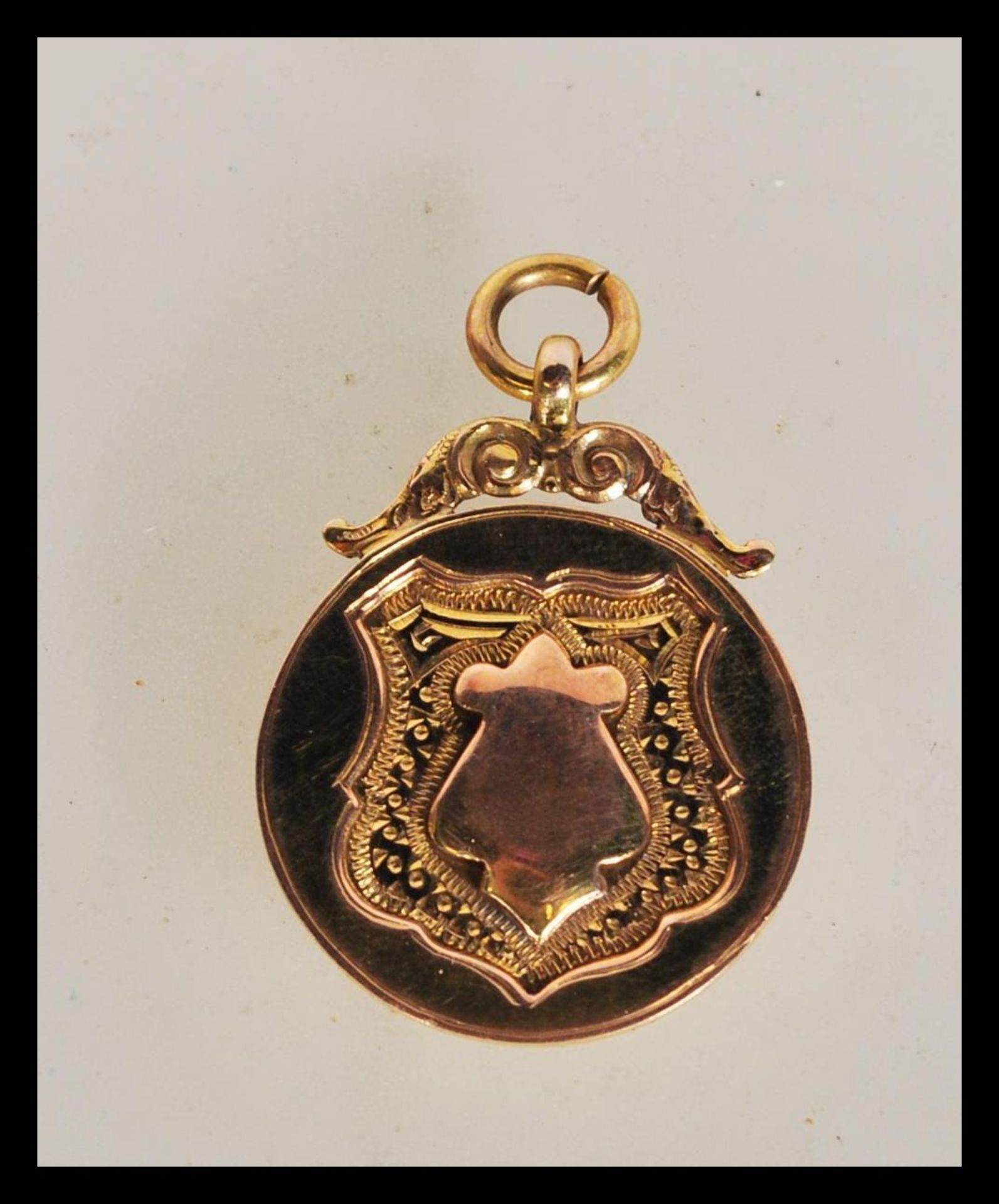 An early 20th Century hallmarked 9ct gold armoril pocket watch chain fob pendant. Weighs 6.1