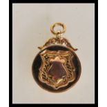 An early 20th Century hallmarked 9ct gold armoril pocket watch chain fob pendant. Weighs 6.1