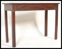 An 19th century George III mahogany hall / side table of rectangular form raised on square canted