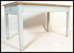 A vintage early 20th Century shabby chic country pine dining table / desk having drawer to one end