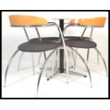 An Italian design dining table and chairs to include four chairs with curved chromed legs and arms