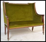 A 19th Century two seater mahogany inlaid Art Nouveau sofa in the manner of Shoolbred, high back