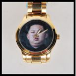 An unusual North Korean Kim Jong Un inspired wrist watch having a pictorial face in fitted