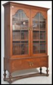 An early 20th Century circa 1920's arts & crafts large oak library bookcase cabinet with arched