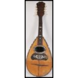 A vintage early 20th Century Mandolin musical instrument. The eight string instrument having