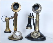 A pair of vintage style brass and bakelite stick telephones, both raised on circular bases with