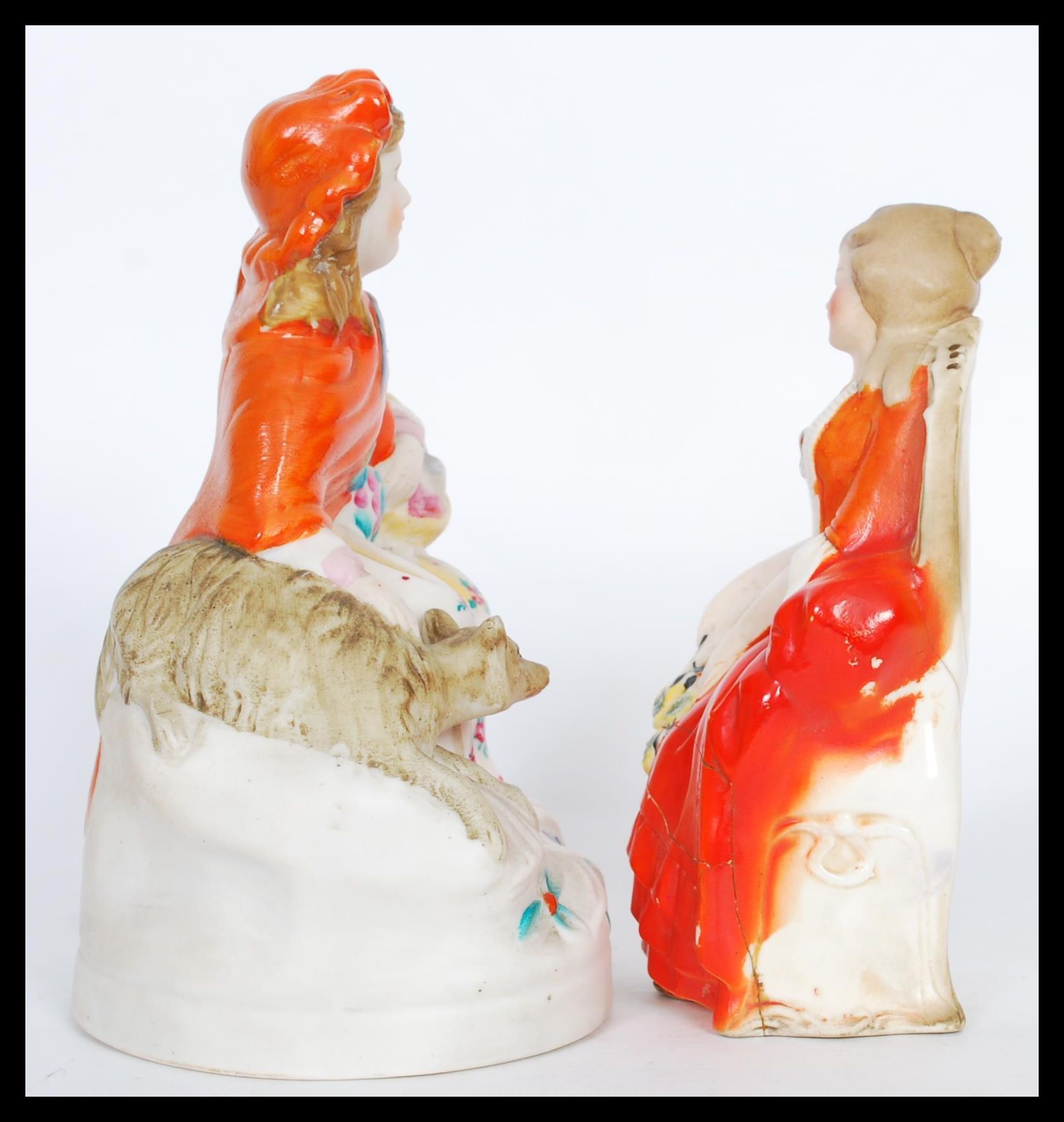 Two 19th Century ceramic figures to include a seated lady with a dog and another seated lady with - Image 2 of 5