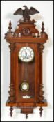 A 20th century Vienna regulated pendulum wall clock of mahogany, with an enamelled face with roman