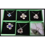 A selection of stamped 925 silver necklaces having hammered floral pendants with central coloured