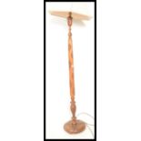 A 20th Century antique style Singapore standard lamp raised on a circular base with tapered column