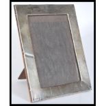 An early 20th Century silver hallmarked photo frame with a varnished wooden back. Hallmarked