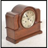 An early 20th Edwardian mahogany inlaid mantel clock having a domed top with inlaid satin wood