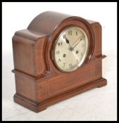 An early 20th Edwardian mahogany inlaid mantel clock having a domed top with inlaid satin wood