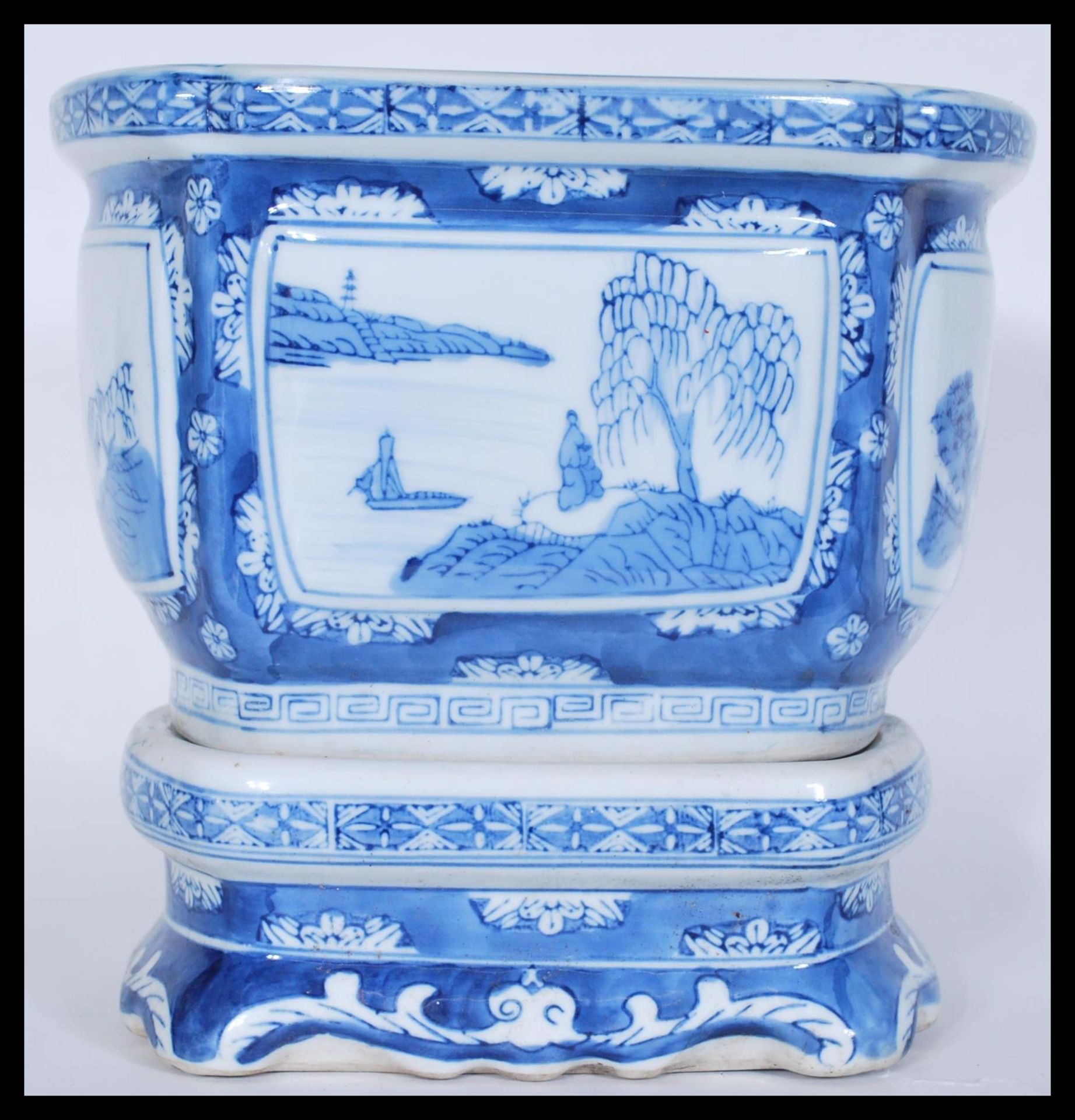 A late 19th / early 20th Century Chinese blue and white jardiniere planter on stand having hand